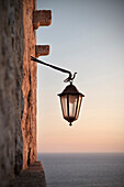 Street lamp with sea in the background in the old town of Ulcinj, Stari Grad, Adriatic coastline, Montenegro, Western Balkan, Europe
