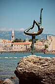 Sculpture of a nude female acrobat in front of old town of Budva, Stari Grad, Adriatic coastline, Montenegro, Western Balkan, Europe