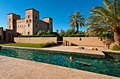 Woman swimming in pool of Dar Ahlam Hotel, Skoura, Morocco