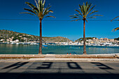 Shadows of letters from Eden Hotel on road in front of beach of Port Soller, Majorca, Spain