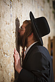 Side view of man praying at Wailing Wall, Jerusalem, Israel