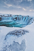 Godafoss with large pieces of ice forming in the cold weather, Iceland
