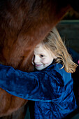 Young Girl Embracing Horse