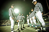 High School Football Referees on Field at Night, Portrait