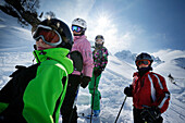 Four children wearing skiwear in snow, ski resort Ladurns, Gossensass, South Tyrol, Italy