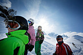 Four children wearing skiwear in snow, ski resort Ladurns, Gossensass, South Tyrol, Italy