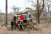 Children playing on a wrecked car near Morondava, West Madagascar, Africa