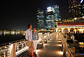 Couple standing on a jetty, Marina Bay, Downtown Core, Singapore