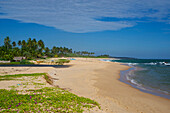 Huts and palm trees on a long deserted sandy beach east of Tangalle, South coast, Sri Lanka, South Asia