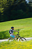 Pedelec cyclist on the way, Upper Bavaria, Germany