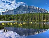 Mount Rundle and boreal forest reflected in Johnson Lake, Banff National Park, Alberta, Canada