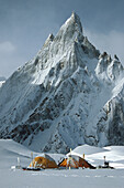 Campsite under icy rock spires after storm on Baltoro Glacier, Karakoram Mountains, Pakistan