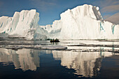 Tourists in zodiac looking at iceberg grounded off Coulman Island, Ross Sea, Antarctica