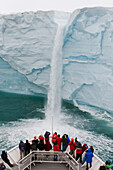 National Geographic Explorer ship approaches waterfall, Austfonna Glacier, Nordaustlandet, Svalbard, Norway