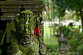 Temple guard figure at the entrance to Tirtha Empul temple at a sacred spring, East of Ubud, central Bali, Indonesia