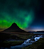 Aurora Borealis over Kirkjufell Mt and waterfall, Snaefellsnes Peninsula, Iceland
