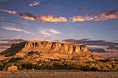 Black Mesa and Adobe church during sunset, Pajartio, New Mexico, USA