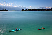 Canoes on lake Forggensee, Allgaeu Alps with Tegelberg, Saeuling and Tannheim mountains in the background, Allgaeu, Bavaria, Germany