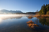 Morning mist, view over lake Barmsee to the Karwendel mountains, near Mittenwald, Bavaria, Germany