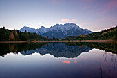 Lake Luttensee in front of the Karwendel mountains at dawn, near Mittenwald, Bavaria, Germany