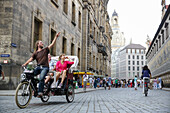 Tourists in a trishaw visiting old town, Dresden, Saxony, Germany