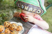 Boy keeping a close eye on muffins, Leipzig, Saxony, Germany
