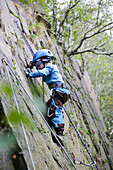 Boy (4 years) climbing at a rock, Gaudlitzberg stone pit, Roecknitz, Thallwitz, Saxony, Germany