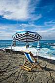 Deck chair and sunshades at coast, Bagni Scogliera, Nervi, Genoa, Liguria, Italia