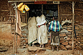 Three women in front of a small shop in the Ethiopian Highlands, Ethiopia, Africa
