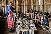 Children and teacher in a Massai village school, Kenya, Africa