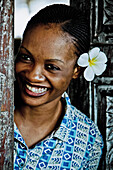Young woman with flower in her hair, Zanzibar, Tanzania, Africa