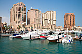 Luxury yachts berthed at Porto Arabia marina at The Pearl Qatar development, Doha, Qatar