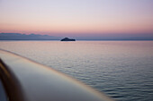 Railing of cruise ship MS Deutschland, Reederei Peter Deilmann, and island with church at dawn, near Dubrovnik, Dubrovnik-Neretva, Croatia