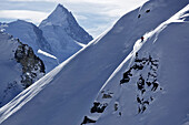 Freeskier downhill skiing in deep snow, Chandolin, Canton of Valais, Switzerland