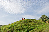 People on a grass-covered hill, Biebrza National Park, Podlaskie Voivodeship, Poland
