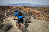 Man mountain biking down a desert trail near Hurricane, Utah Hurricane, Utah, USA