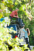 A couple load luggage onto the roof of a van while traveling in Florida Florida, USA