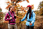 Two young women laughing together while out hiking in the Columbia River Gorge, Oregon Hood River, Oregon, USA
