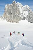 A group of backcountry skiers cross tracks in the Selkirk Mountains, Canada British Columbia, Canada
