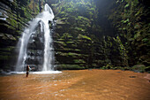 A woman observes a waterfall in Brazil Brazil