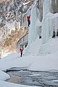 A man is belayed while climbing an ice pillar on a highway in Sounkyo Gorge, Daisetsuzan National Park, Hokkaido, Japan Hokkaido, Japan