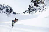 A group of skiers in the backcountry on a clear day Washington, USA