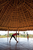 A woman practicing yoga in a pavilion overlooking Sayulita Puerto Vallarta, Mexico