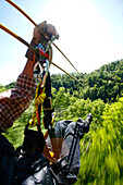 Shot of man on zipline at a forest canopy tour Asheville, North Carolina, USA