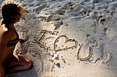 Woman writes I love you on the beach in Mexico Playa Del Carmen, Quintana Roo, Mexico
