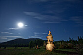 Rock cairn with a full moon in background in Idaho Sandpoint, Idaho, USA