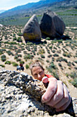 A woman bouldering at the Buttermilks, California Bishop, California, USA