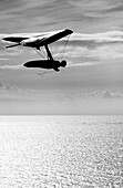 A man soars above the pacific ocean in a hang glider Santa Barbara, California, USA