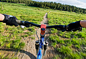 A young woman catches a quick mountain bike ride before the sun goes down in Lake Tahoe, Nevada Incline Village, Nevada, USA