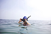 Female swimmer takes snorkel off after swimming the Cove in La Jolla La Jolla, CA, USA